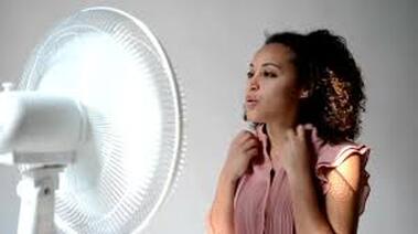 Woman in front of fan